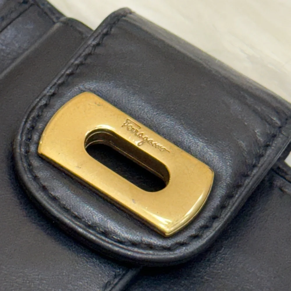 SALVATORE FERRAGAMO - BLACK LEATHER GOLD PLATED SECURE CLOSURE BIFOLD WALLET